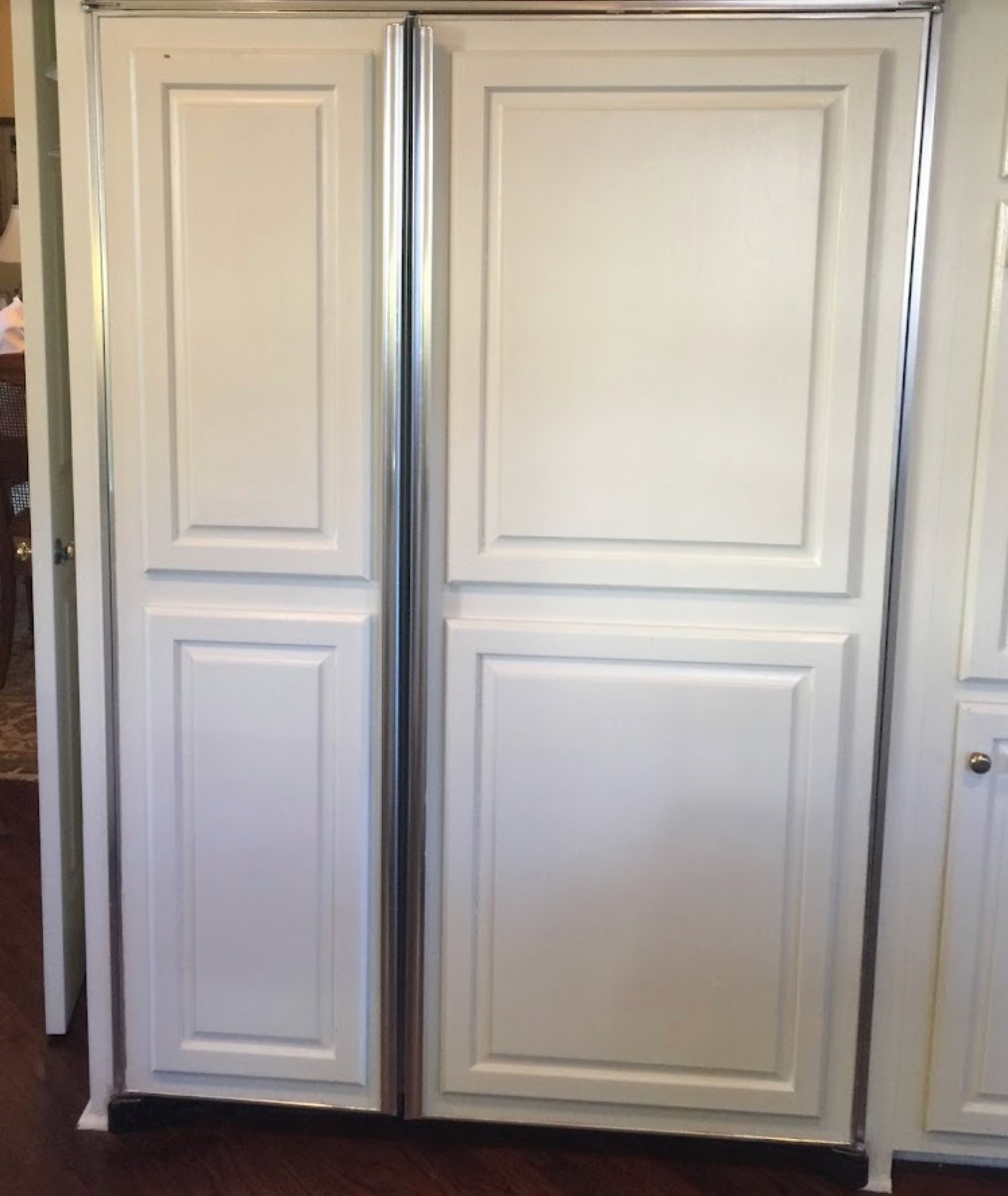 White two-panel sliding closet doors with recessed panels and metal frame